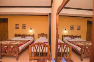A bed or beds in a room at Wathsala Inn