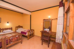A bed or beds in a room at Wathsala Inn