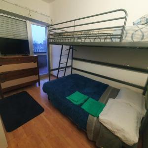 a bedroom with a bunk bed and a television at B&B MaKri in Boltiere