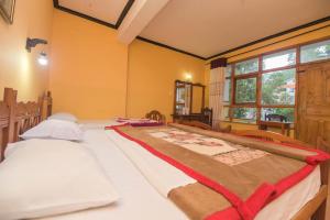 A bed or beds in a room at Wathsala Inn