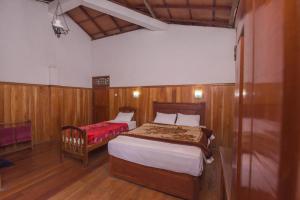 A bed or beds in a room at Wathsala Inn
