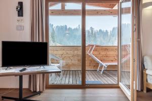 an office with a desk and a computer on a balcony at Ferienparadies Sabina Birke in Alpe di Siusi