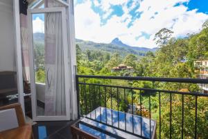 a balcony with a view of the mountains at Wathsala Inn in Adams Peak