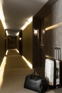 a suitcase is sitting on the floor in a room at Radisson Blu Park Hotel Athens in Athens