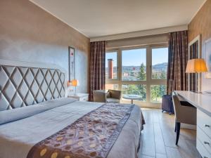 Postel nebo postele na pokoji v ubytování Parc Hotel Gritti