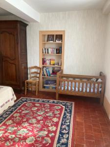 a bedroom with a bed and a book shelf at La maison de Jeannot in Aisy-sous-Thil