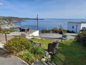 a yard with a view of a body of water at Eddystone Light Apartment in Mevagissey