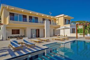 a villa with a swimming pool and a house at Luxury Villa Hvar Deluxe Palace 1 with heated pool, gym and sauna in Hvar