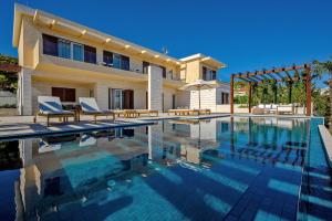 a villa with a swimming pool and a house at Luxury Villa Hvar Deluxe Palace 1 with heated pool, gym and sauna in Hvar