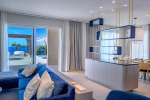 a living room with a blue couch and a table at Luxury Villa Hvar Deluxe Palace 1 with heated pool, gym and sauna in Hvar
