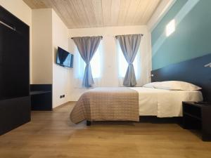 Postel nebo postele na pokoji v ubytování Il B&B di PIAZZA MOTTA
