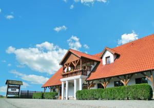 a large building with a red roof at Zajazd Pod Kogutkiem in Busewo