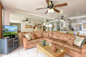 a living room with a couch and a flat screen tv at Maalaea Kai 305 in Maalaea