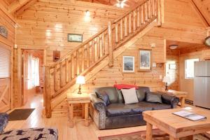 a living room with a couch in a wooden cabin at Sleepy Willow Cabin in Sevierville