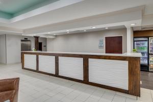 a lobby of a hospital with a counter with white doors at MySuites Lawton in Lawton