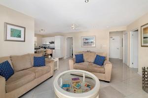 a living room with two couches and a table at Lantana 42 in Saint James