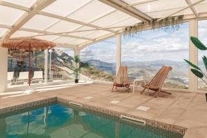 a house with a swimming pool and two chairs at Paraíso Douro AL in Lamego