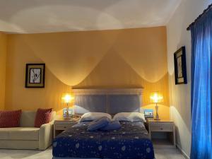 A bed or beds in a room at Arginonta Beach Apartments