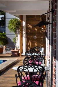 a group of benches sitting on a porch with a table at Espina Hotel in Antalya