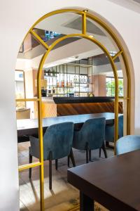 a dining room with a table and blue chairs at Espina Hotel in Antalya