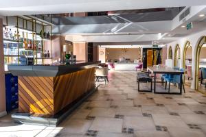 a bar in a restaurant with a table and chairs at Espina Hotel in Antalya