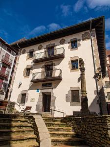 a large white building with stairs in front of it at Hotel Palacio Branka in Mundaka