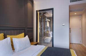 a bedroom with a bed and a window with a bird in a cage at Espina Hotel in Antalya