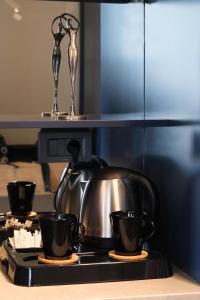 a tea kettle and two cups on a stove at Espina Hotel in Antalya