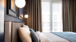 a bedroom with a bed and a large window at Espina Hotel in Antalya