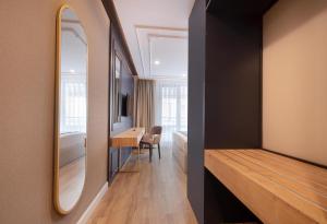 a bedroom with a mirror and a desk in a room at Espina Hotel in Antalya