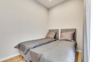 a bed with two pillows on it in a bedroom at Central Platinum Apartments 28 z balkonem in Rybnik
