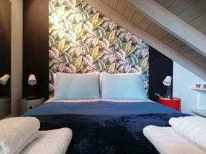 a bedroom with a large bed with a floral wallpaper at Argostoli loft in Argostoli