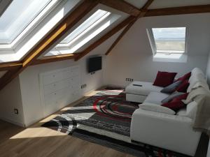 a living room with skylights and a white couch at Playa de Barrañan in Arteixo