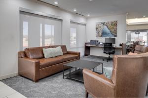 an office with a couch and chairs and a desk at MySuites Lawton in Lawton