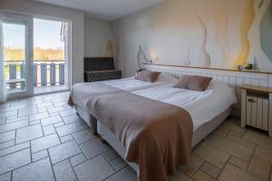 Een bed of bedden in een kamer bij Hotel Tesselhof