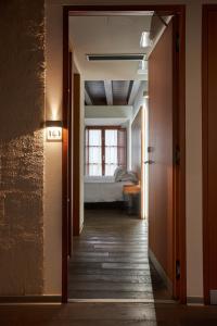 a hallway leading to a bedroom with a bed at María Pacheco Hotel Boutique in Ávila