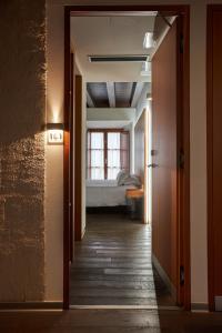 a hallway leading to a bedroom with a bed at María Pacheco Hotel Boutique in Avila