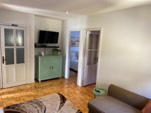 a living room with a couch and a television at House T3 in Vila Nova de Gaia