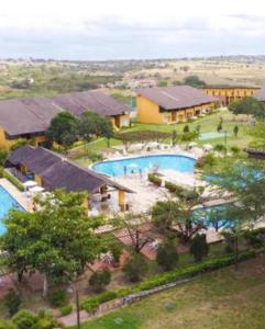 an aerial view of a resort with a swimming pool at Winterville Gravata Flat Residence in Gravatá