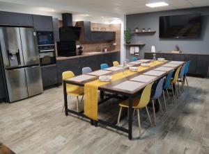 a large kitchen with a long table and chairs at Villa Raphaëlle #3 Centre ville avec parking in Le Havre