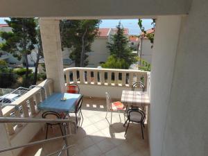 a balcony with a table and chairs on a porch at Studios Ravlić Marija in Makarska