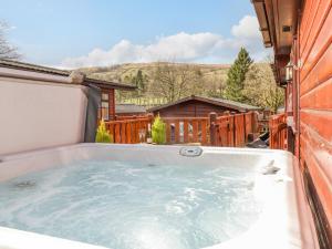 a hot tub in the backyard of a house at Limefitt Lodge in Windermere