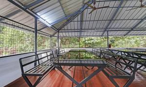 a group of benches sitting inside of a building at Treebo Trend Nirupama Apartment in Alwaye