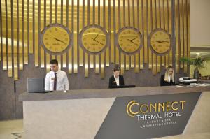 a group of people sitting at a counter with clocks at CONNECT THERMAL HOTEL in Ankara