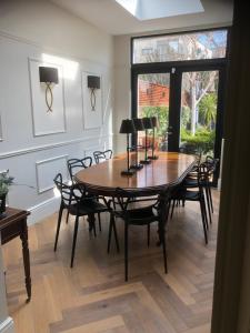 a dining room with a wooden table and chairs at Blackrock B&B in Dublin