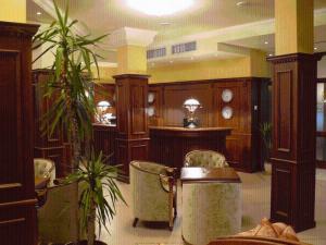 a room with chairs and tables in a building at Hotel Bordo in Plovdiv