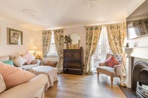 a living room with a couch and a fireplace at Thomas Wyatt House - Norfolk Holiday Properties in Norwich