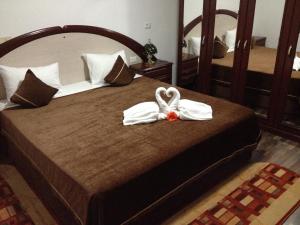 Un pat sau paturi într-o cameră la Pensiunea la Nise