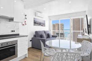 a kitchen and living room with a table and chairs at Albatros Deluxe 15-5 Apartment Levante Beach in Benidorm