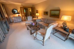 a living room with a couch and a table at Apartment Chalet Rubihorn mit Berg-Blick in Bolsterlang